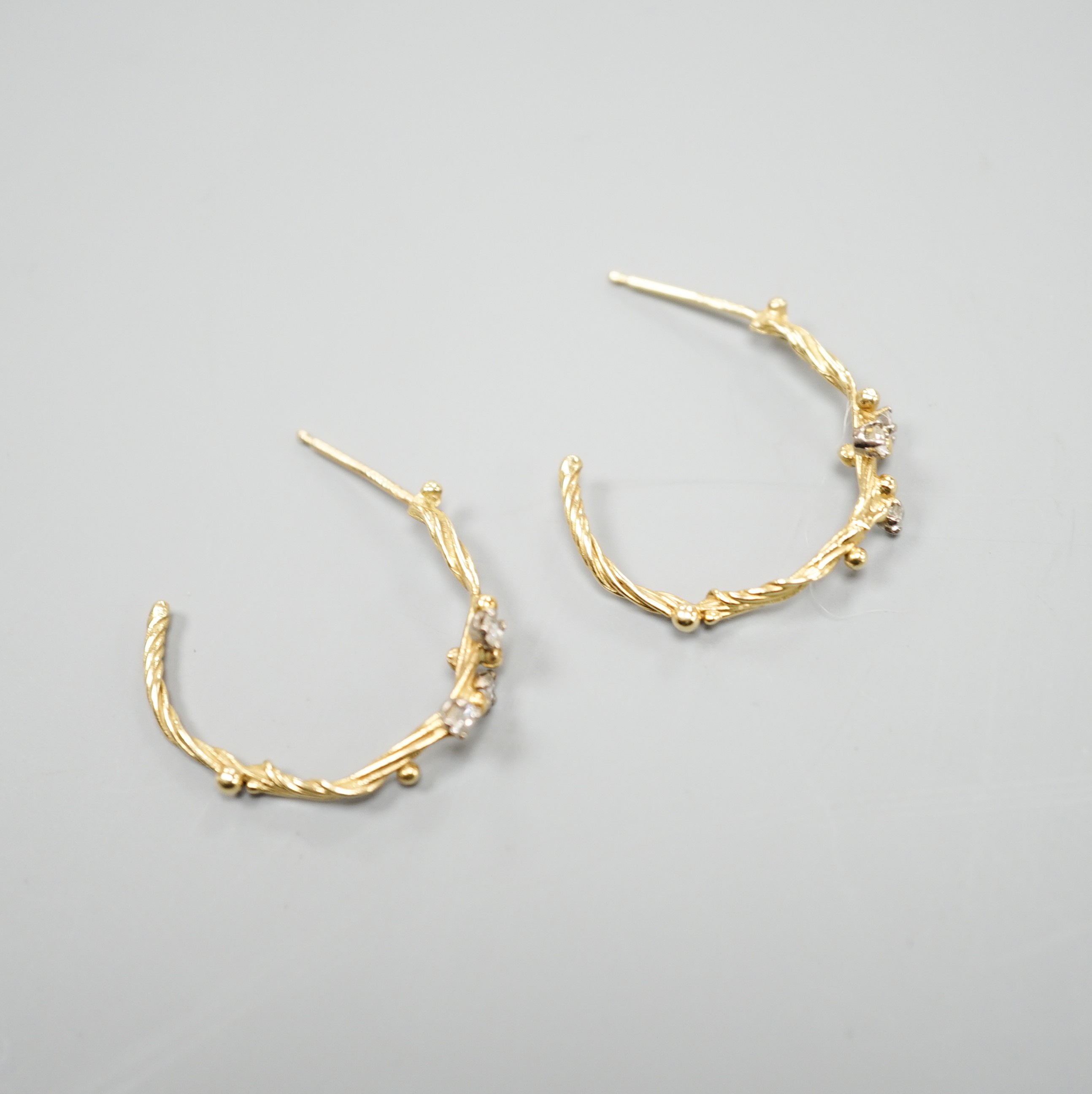 A pair of 18ct gold and three stone diamond set rustic hoop earrings, no butterflies, 25mm, gross weight 3.5 grams.